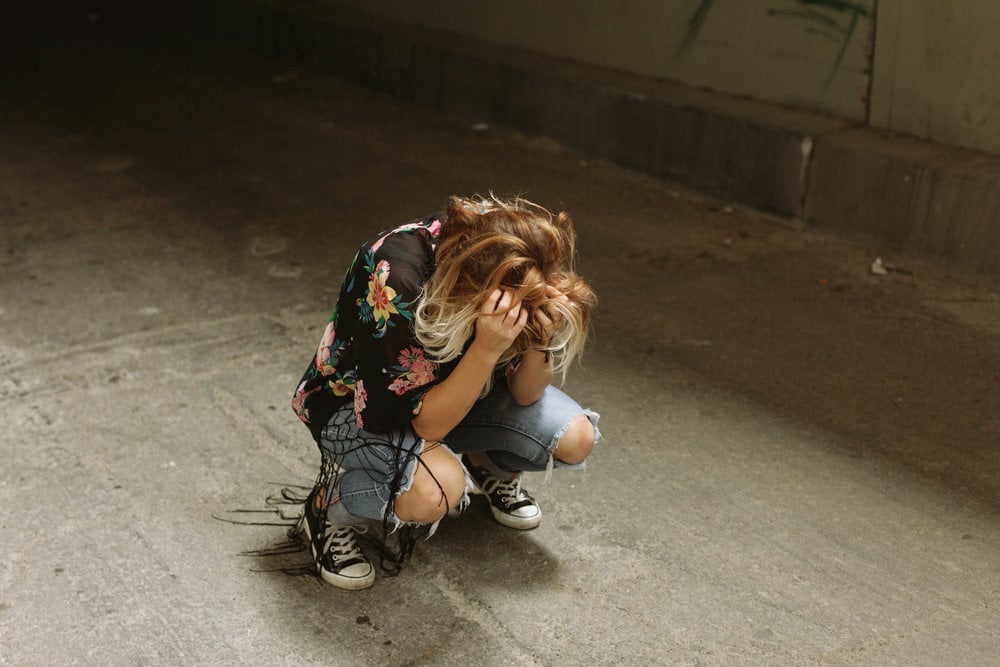 Women Crying in tattered jeans